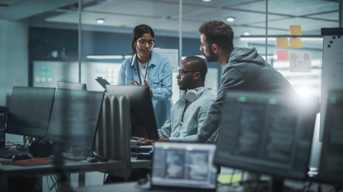Diverse Group of Professionals Meeting in Modern Office: IT Programmers Use Computer, Talk Strategy, Discuss Planning and security