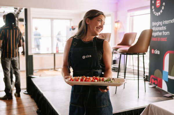 Server holding appetizers smiling