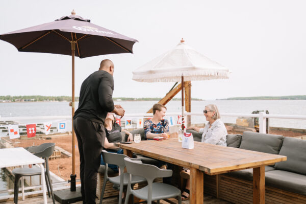 Four people smiling on a patio