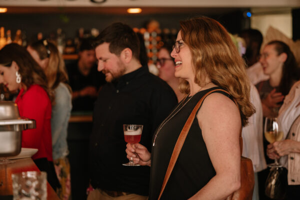 Woman smiling holding a drink