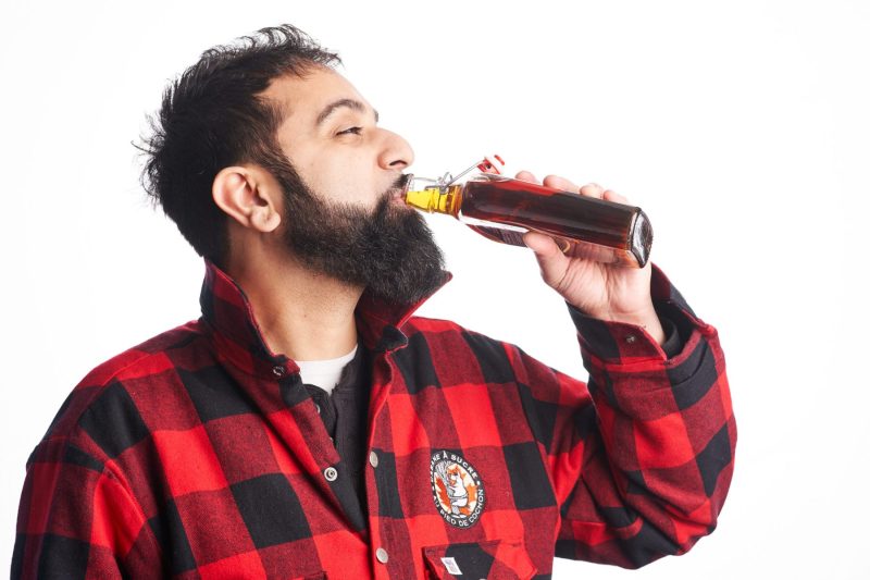 Lumberjack enjoys swig of tasty maple syrup