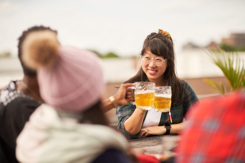 Woman enjoys beer with friends