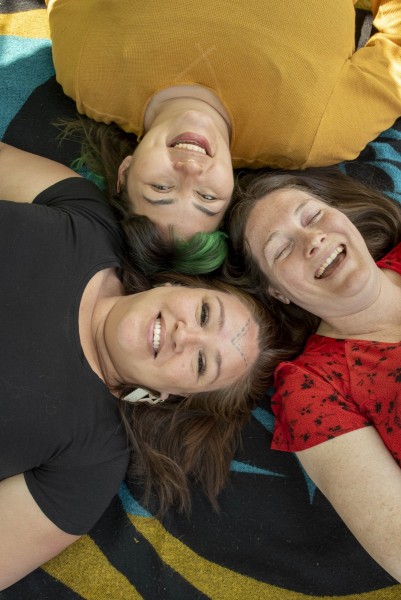 Photo of women laying on a picnic blanket